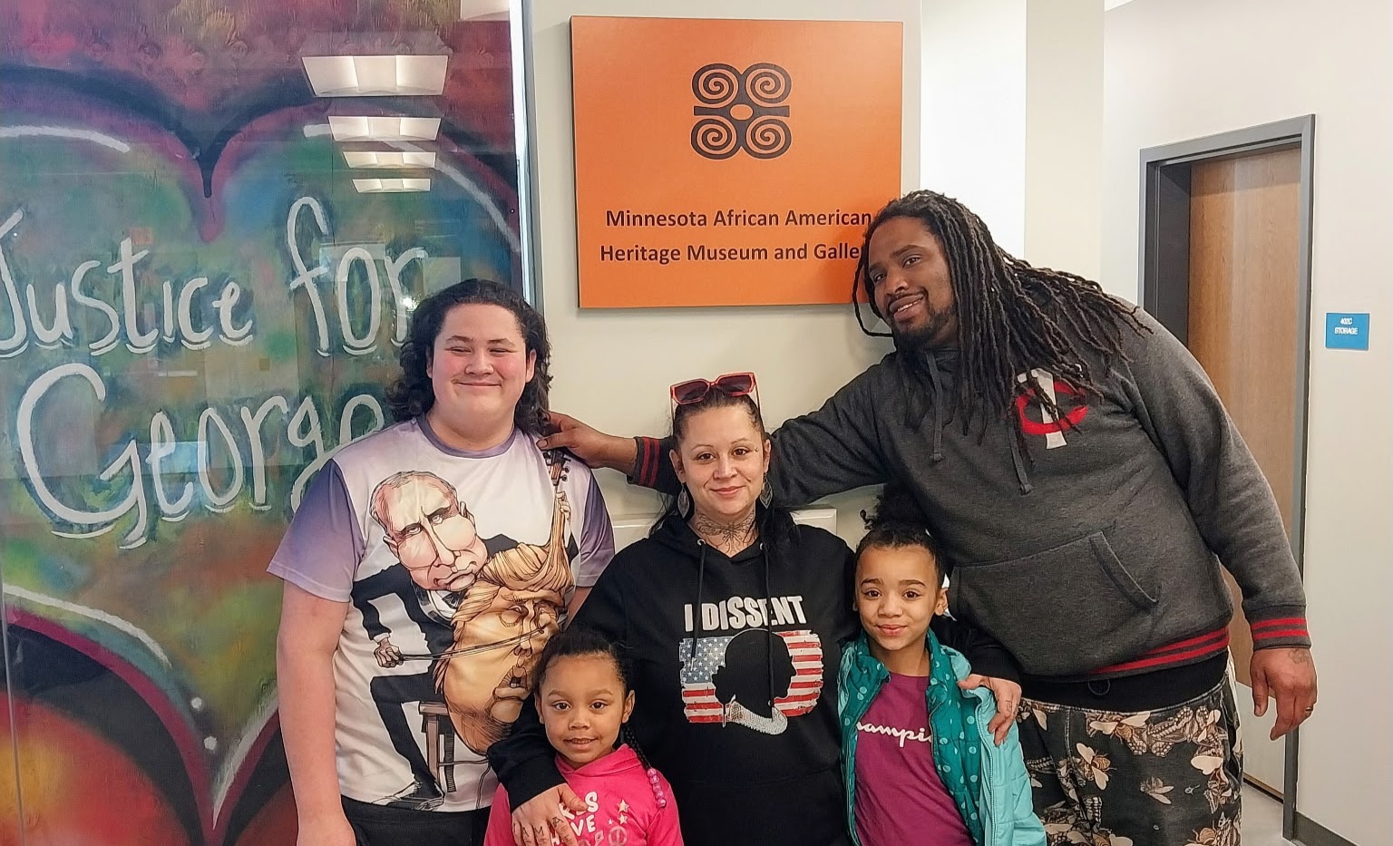 Amber and her family at the Minnesota African American Heritage Museum and Gallery, beside a Justice for George mural