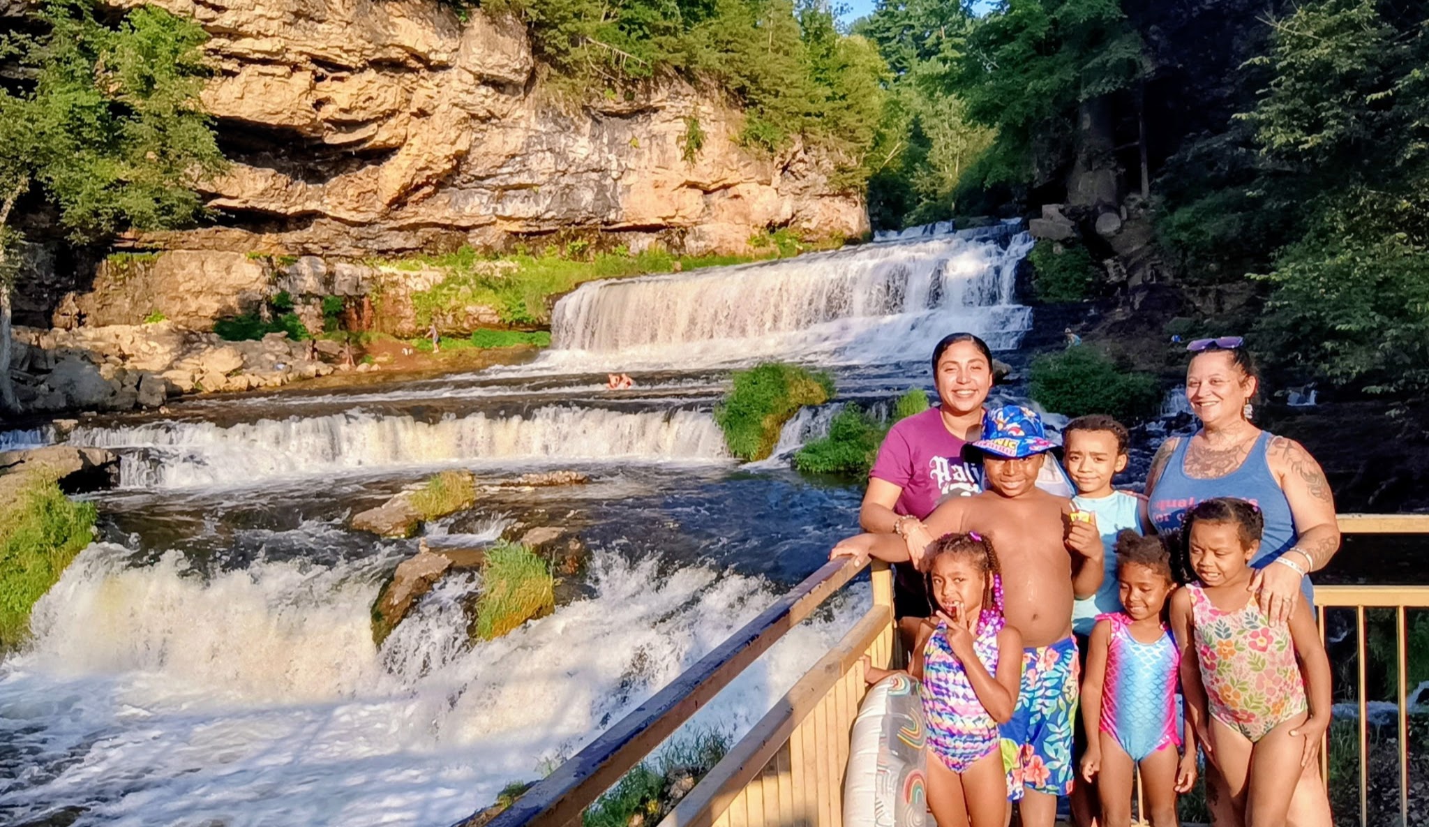 Amber and the kids at the falls on a summer evening